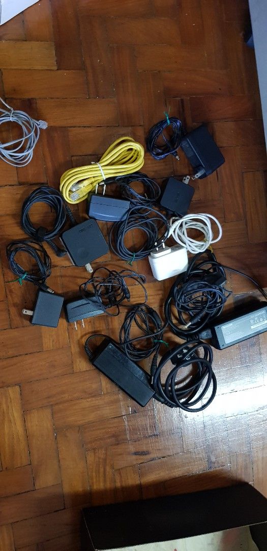 PLDT and Other Routers and Accessories (Category: Networking) located in Makati City. Submitted by walangtubo (Listing ID 1429507056, Image 3). Description: TAKE ALL ONLY , NO CHOOSING. IM NO EXPERT SO DONT ASK QUESTIONS, SEE PHOTOS CLEARING HOME Assorted routers and networking equipment, including PLDT-branded devices. Includes various routers, power adapters, and network cables. Some items appear to be in their original boxes. Cables are of dif