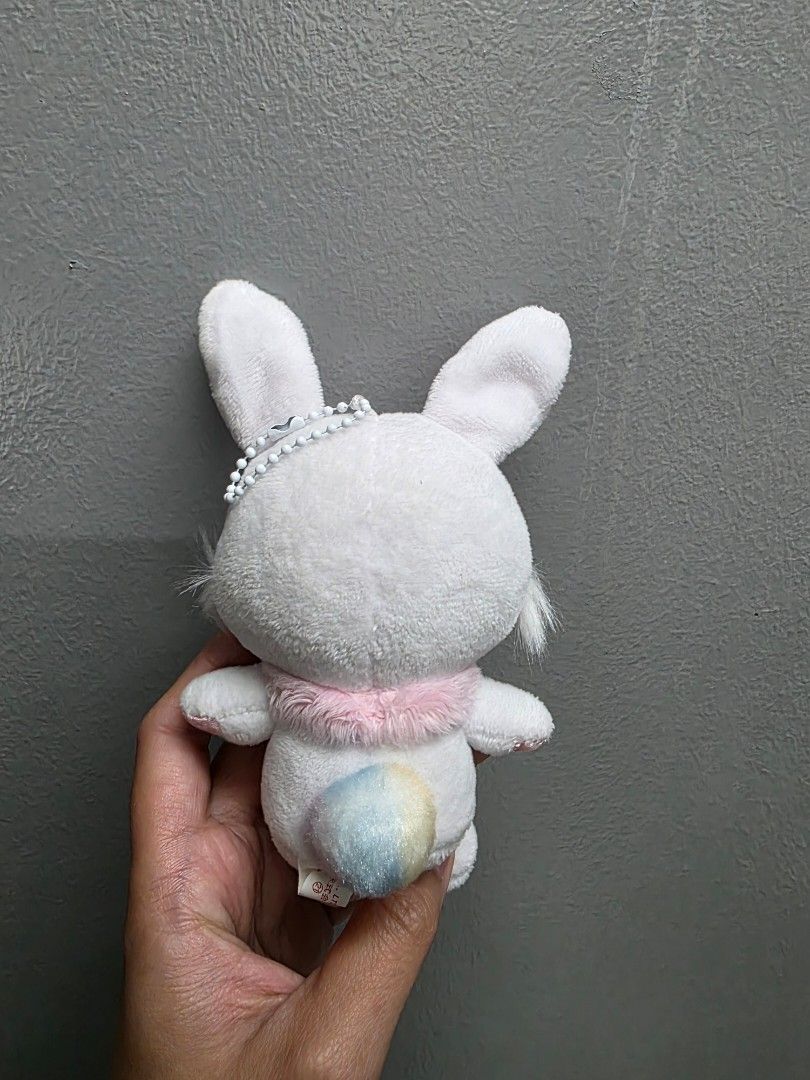 Sanrio Wish Me Mell Charm (Category: Plushies & Soft Toys) located in Valenzuela. Submitted by cbianx (Listing ID 1429586488, Image 2). Description: Adorable Sanrio wish me mell plush toy. Features a white body with pink accents on the ears and feet. It has a cute pink collar with a purple bow. The bunny has embroidered yellow eyes and a small tail. The tag indicates it is a Sanrio product..