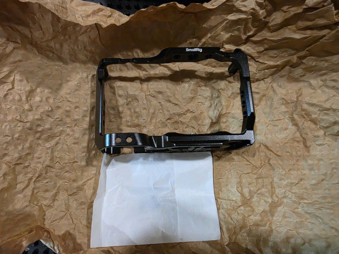 SmallRig ZV-E10 Camera Cage (Category: Cameras) located in Makati City. Submitted by lilyignacio81 (Listing ID 1429504762, Image 2). Description: SmallRig camera cage designed for the ZV-E10 . It has multiple mounting points and is compatible with the RS 2. The cage is black and includes a base plate. The box is included. The cage has "OFF/ON" markings..