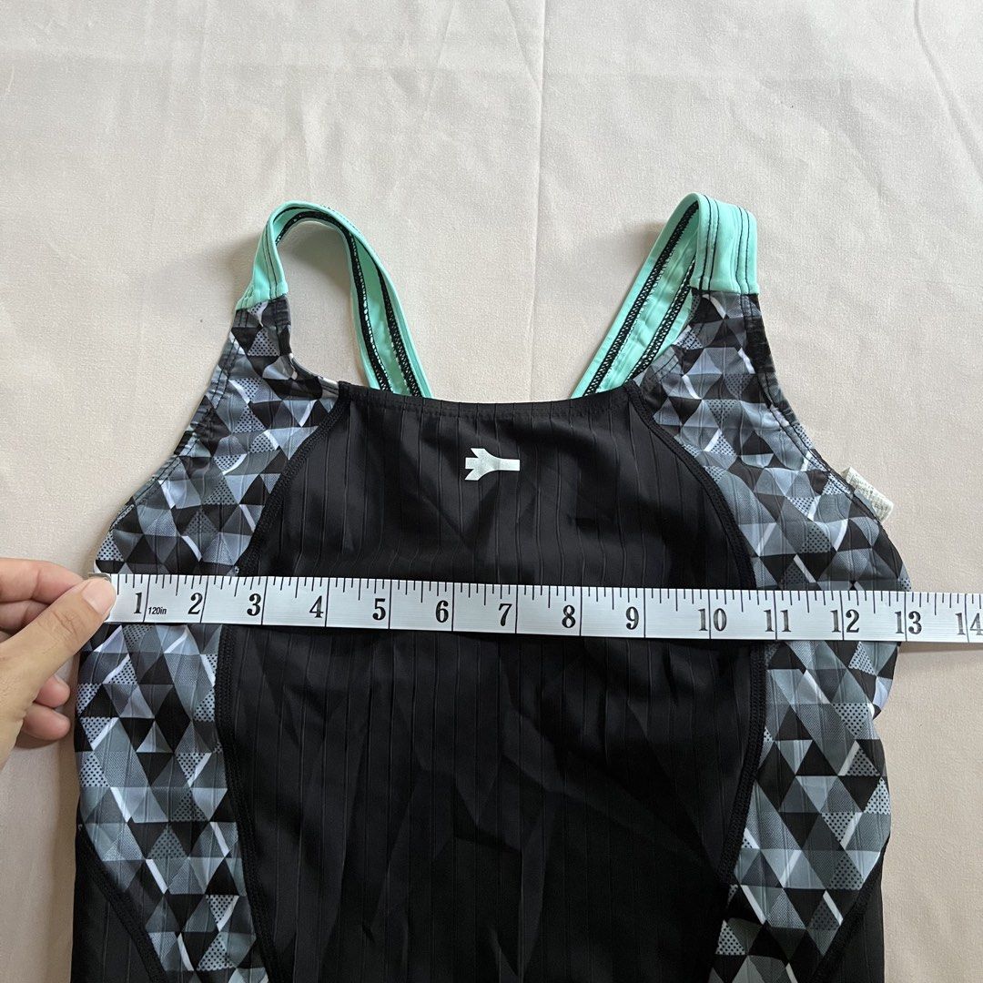 Renoma Kneesuit (XL) (Category: Bikinis & Swimsuits) located in Panabo. Submitted by munch.ph (Listing ID 1429579505, Image 2). Description: Renoma kneesuir features a striking black and geometric design with teal accents. It has a full-body coverage design. The swimsuit has a measurement of approximately 12 inches across the chest. The leg opening measures about 8 inches. The tag indicates the size is 95-100 (BK)..