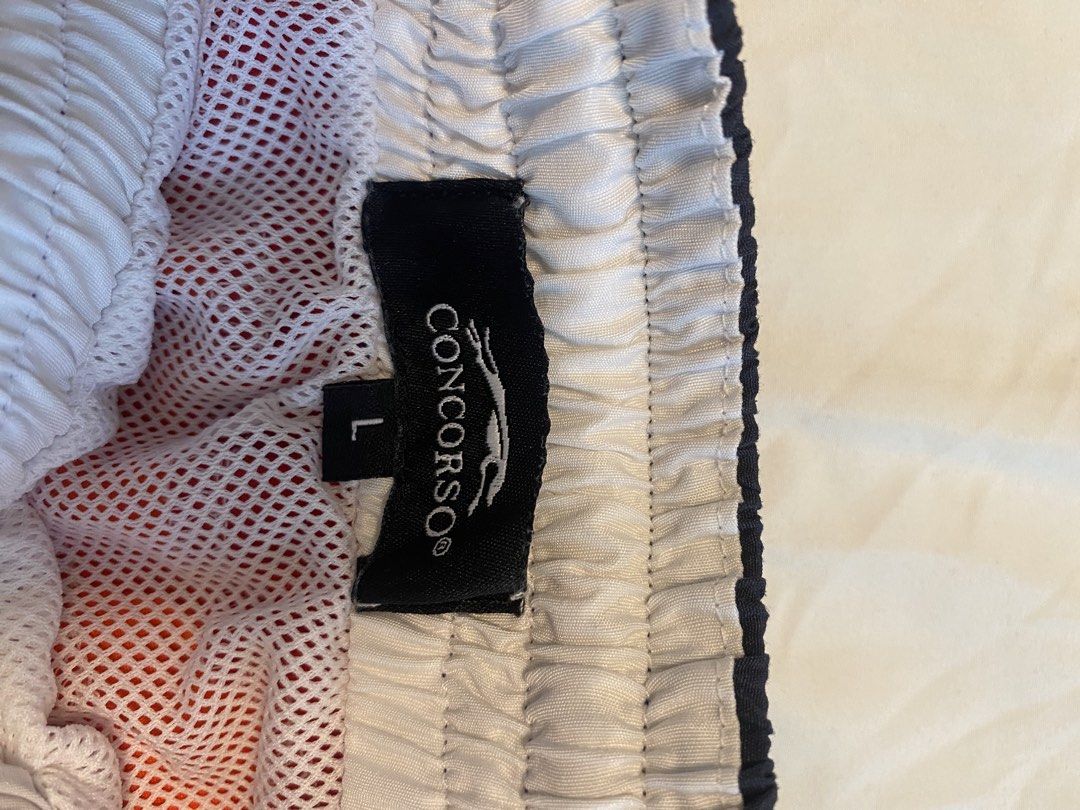 Swim Shorts x2 (Category: Swim Trunks & Board Shorts) located in Makati City. Submitted by rye16 (Listing ID 1429563262, Image 2). Description: - Two pairs of Concorso swim shorts - Size: Large - Includes: - White shorts with rainbow stripe waistband - Blue floral shorts.