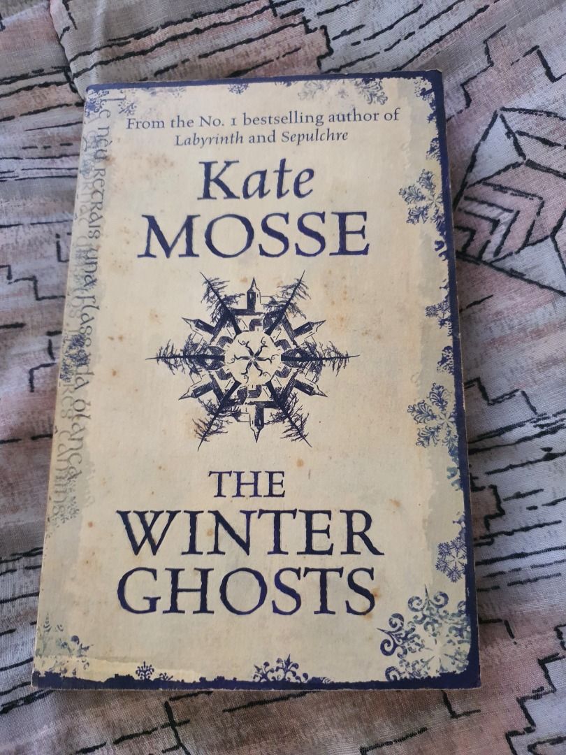The Winter Ghosts by Kate Mosse (Category: Storybooks) located in Quezon City. Submitted by cuiquesuum (Listing ID 1429552731, Image 1). Description: Light, foxing spots and a tanned oxidation to the pages. The binding is secure. There is a 2-line writing on the first page by the previous owner. Cover is intact but shows clear, noticeable wear, such as scuffs, minor creases, or edge wear. It is in perfectly readable condition. .