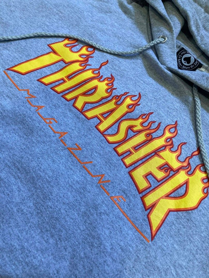 Thrasher Magazine Hoodie - Gray (Category: Hoodies) located in General Santos City (Dadiangas). Submitted by amorhesthrift (Listing ID 1429536408, Image 2). Description: W25.5 L28 Gray Thrasher Magazine hoodie. Features the iconic Thrasher logo on the front. It has a hood with drawstrings and a kangaroo pocket. The tag indicates it is a size L (42-44). Made in Honduras. The material is 85% cotton and 15% polyester..