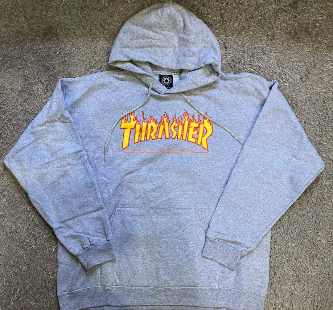 Thrasher Magazine Hoodie - Gray (Category: Hoodies) located in General Santos City (Dadiangas). Submitted by amorhesthrift (Listing ID 1429536408, Image 1). Description: W25.5 L28 Gray Thrasher Magazine hoodie. Features the iconic Thrasher logo on the front. It has a hood with drawstrings and a kangaroo pocket. The tag indicates it is a size L (42-44). Made in Honduras. The material is 85% cotton and 15% polyester..