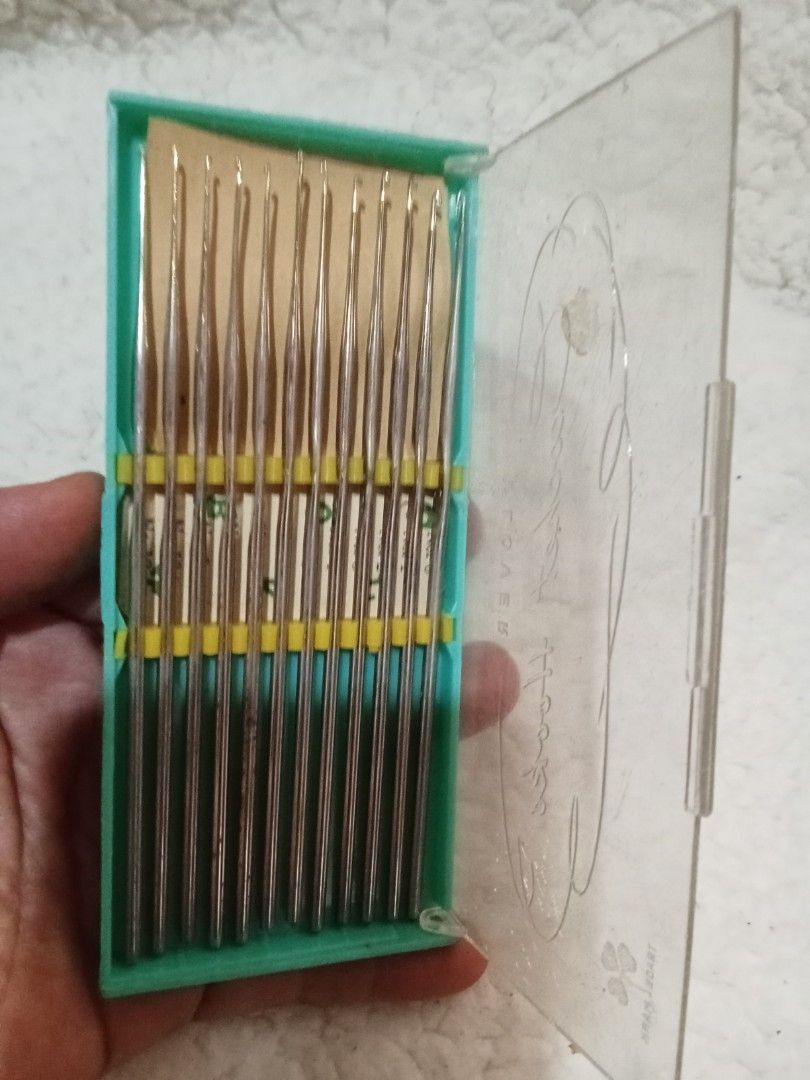 Vintage Crochet Hook Set (Category: Craft Supplies & Tools) located in Bocaue. Submitted by marajapansurplus (Listing ID 1429548671, Image 1). Description: Vintage set of crochet hooks. The set includes multiple hooks of varying sizes, neatly organized in a green plastic case with a clear lid. The case has a yellow band to hold the hooks in place. Perfect for crochet enthusiasts..