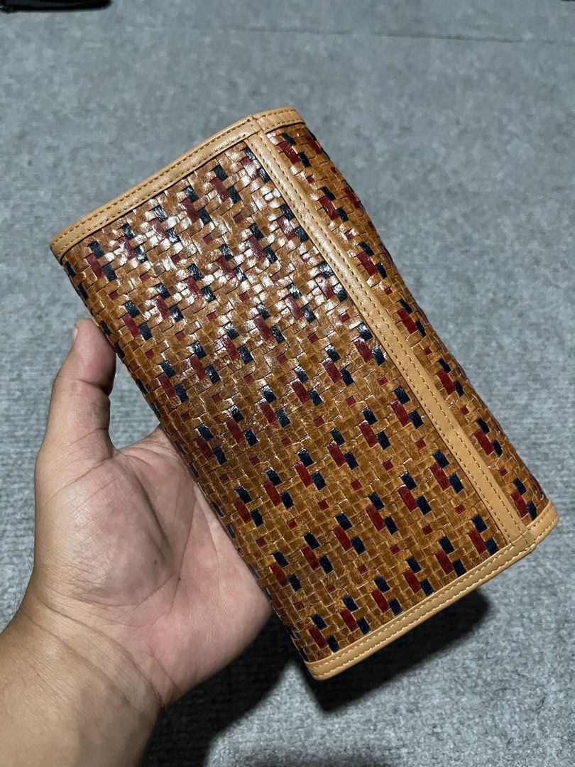 Vivienne Westwood Wallet (Category: Luxury Bags & Wallets) located in Manila. Submitted by ketchidrip.ph (Listing ID 1429568926, Image 2). Description: Authentic Vivienne Westwood wallet featuring a woven design with red and blue accents. It has a silver-tone emblem on the front and a snap closure. The interior includes multiple card slots, a zippered compartment, and the Vivienne Westwood logo. Comes with a card. Issue: Last pic.