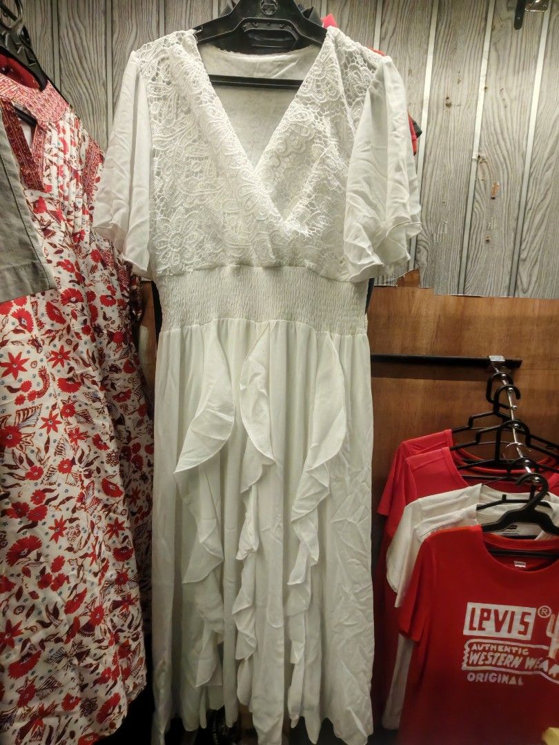 White Ruffled Dress (Category: Dresses) located in Quezon City. Submitted by rowem (Listing ID 1429641775, Image 2). Description: Elegant white dress featuring a V-neckline and short sleeves. The bodice has a lace overlay, and the waist is cinched. The skirt flows with ruffled details. Perfect for special occasions or a chic, feminine look..