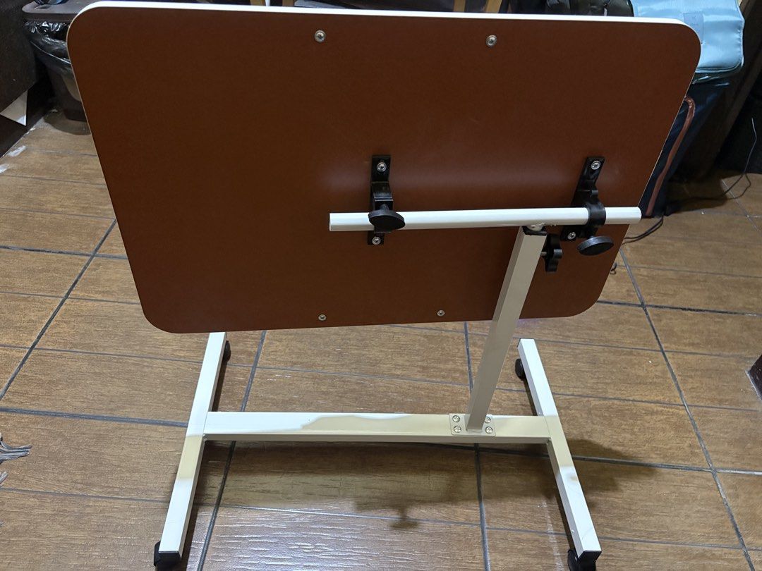 Adjustable Folding Laptop Side Work Table with Wheels (Category: Tables & Sets) located in Mandaluyong City. Submitted by cosmopolly123 (Listing ID 1431305500, Image 2). Description: Foldable and height adjustable table for sale. Just received and assembled today (April 10). Only been used once to check laptop size. RFS: size is too big for room Location: Mandaluyong or nearby areas Shipping fee will be shouldered by the buyer.