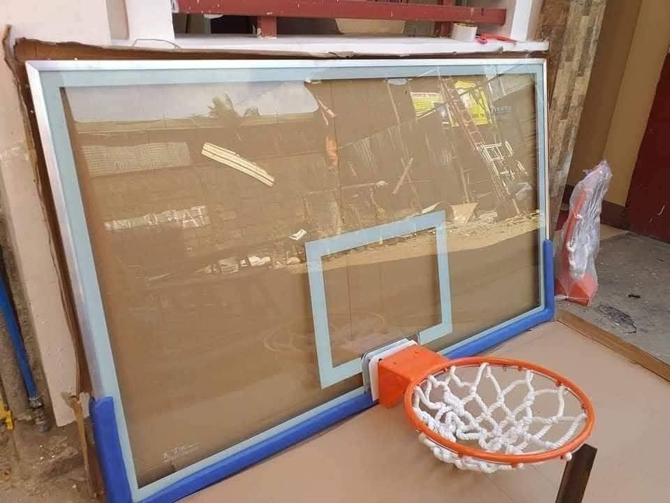 Basketball Hoop with Glass Backboard (Category: Racket and Ball Sports) located in Manila. Submitted by lyka.sofitec (Listing ID 1431320442, Image 1). Description: - New basketball hoop - Clear glass backboard with a blue frame - Orange rim and white net - Suitable for indoor and outdoor use - Perfect for all ages.