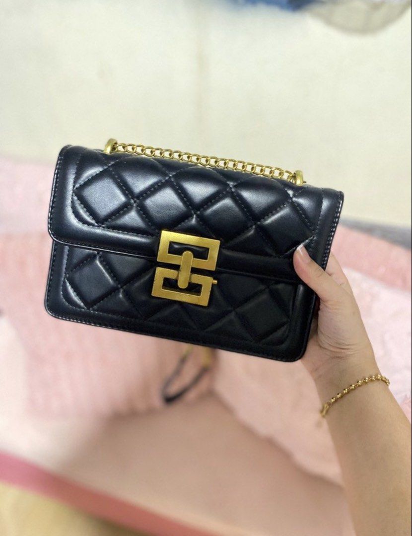 Black Quilted sling with Gold Chain (Category: Luxury Bags & Wallets) located in Manila. Submitted by declutterwithpeanut (Listing ID 1430962759, Image 1). Description: Elegant black handbag with a quilted design. Features a gold chain strap and a gold-colored clasp. It has a rectangular shape and a flap closure..