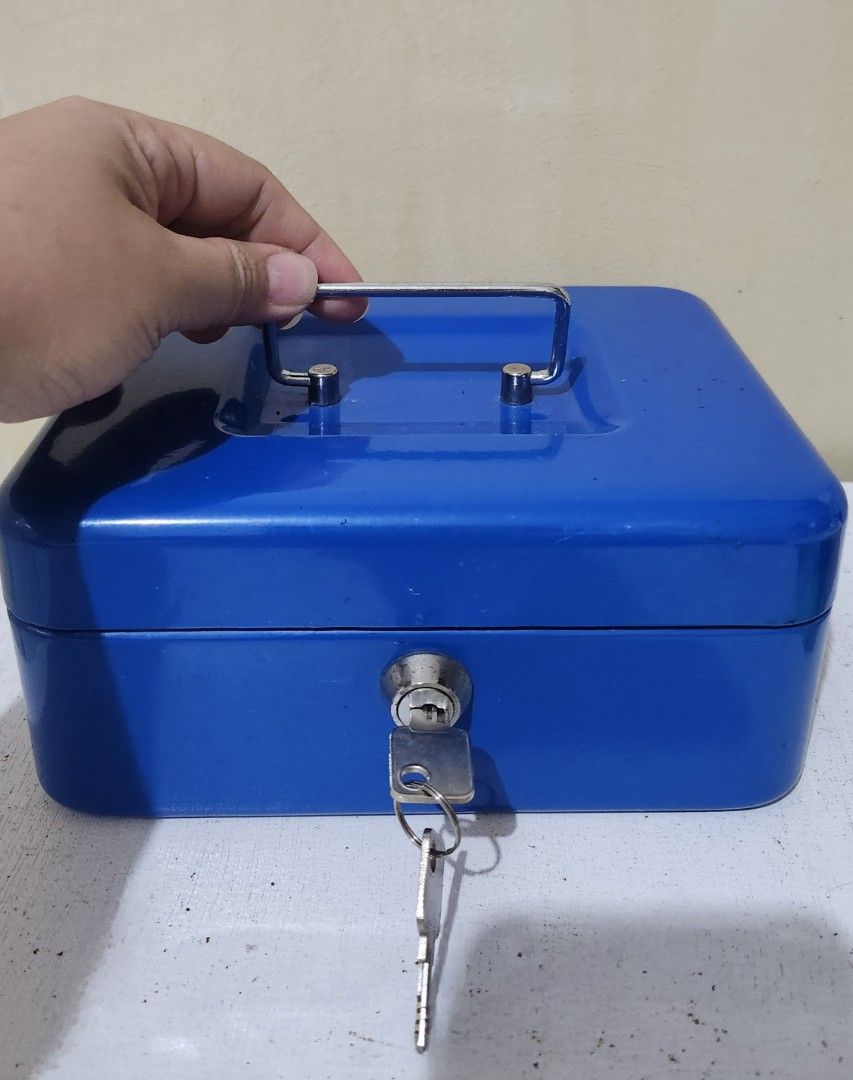 Blue Metal Cash Lock Box with keys (Category: Everything Else Others) located in Quezon City. Submitted by dannikkishoppe2 (Listing ID 1431238976, Image 3). Description: Blue Metal Cash Lock Box with keys ₱250‼️ L8 W6 H3.5 inches heavy Blue cash box includes a key for secure storage. It features a handle for easy carrying and a compartmented interior for organizing contents. The box has a lock to keep your valuables safe. It is a practical soluti