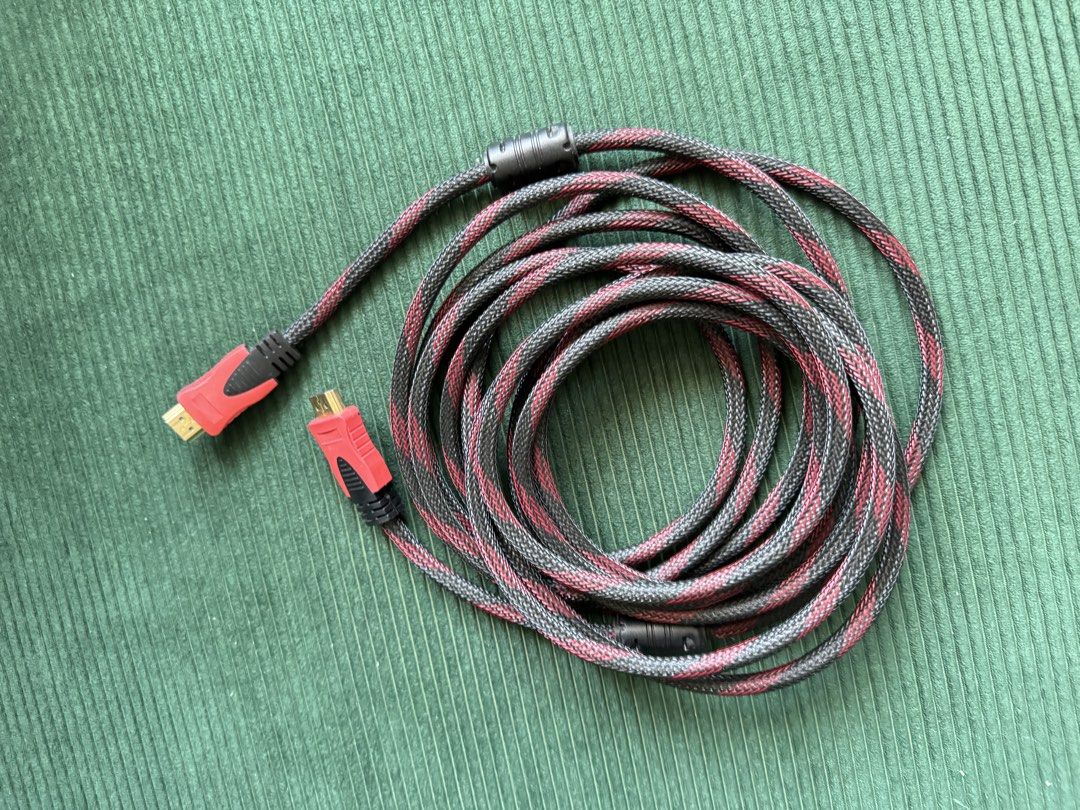 Braided HDMI Cable 5 meters (Category: Cables & Adaptors) located in Manila. Submitted by bingnthings (Listing ID 1431371568, Image 1). Description: - Braided HDMI cable - Red and black accents - Standard HDMI connectors - Coiled design - Connects devices to displays.