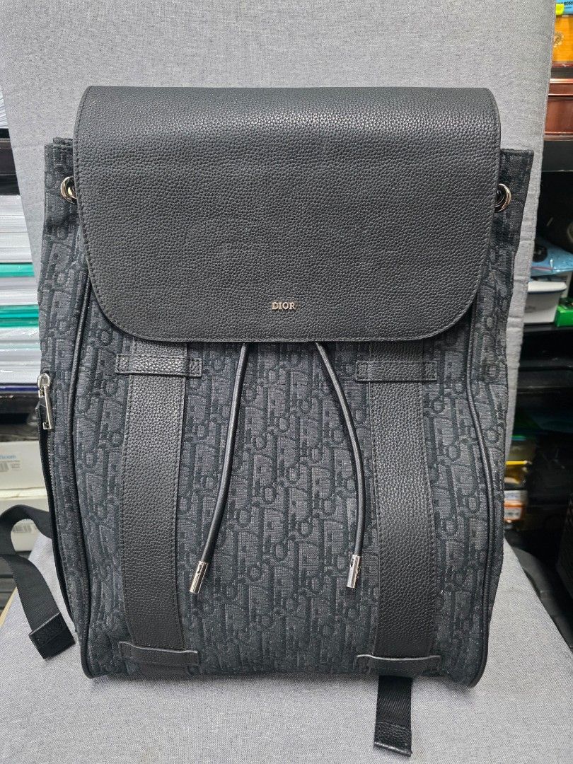 Christian Dior Oblique Backpack (Category: Luxury Bags & Wallets) located in General Trias. Submitted by roselle2230 (Listing ID 1431275068, Image 1). Description: Authentic Christian Dior backpack in black. Features the iconic Dior Oblique pattern. Includes adjustable straps with Christian Dior branding. The interior has a drawstring closure and a Dior label. Made in Italy. Includes a leather flap with the Dior logo. The backpack has a mesh back
