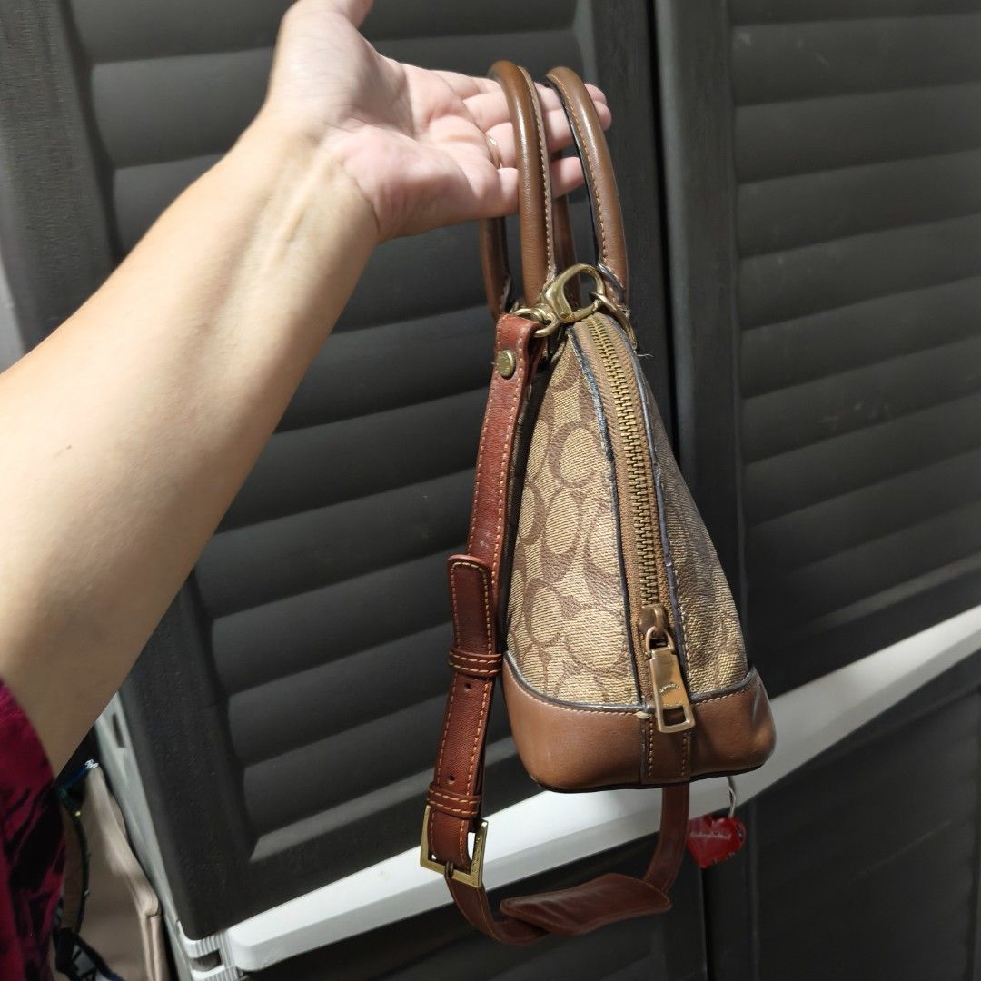 Coach Dome Satchel Handbag (Category: Cross-body Bags) located in Manila. Submitted by stuff_finder (Listing ID 1431189863, Image 2). Description: Coach dome satchel handbag with brown leather trim and signature logo print. Features a top handle and a detachable shoulder strap provided. The interior has a pocket. Includes a Coach hangtag. The bag has a zip closure. guaranteed authentic.