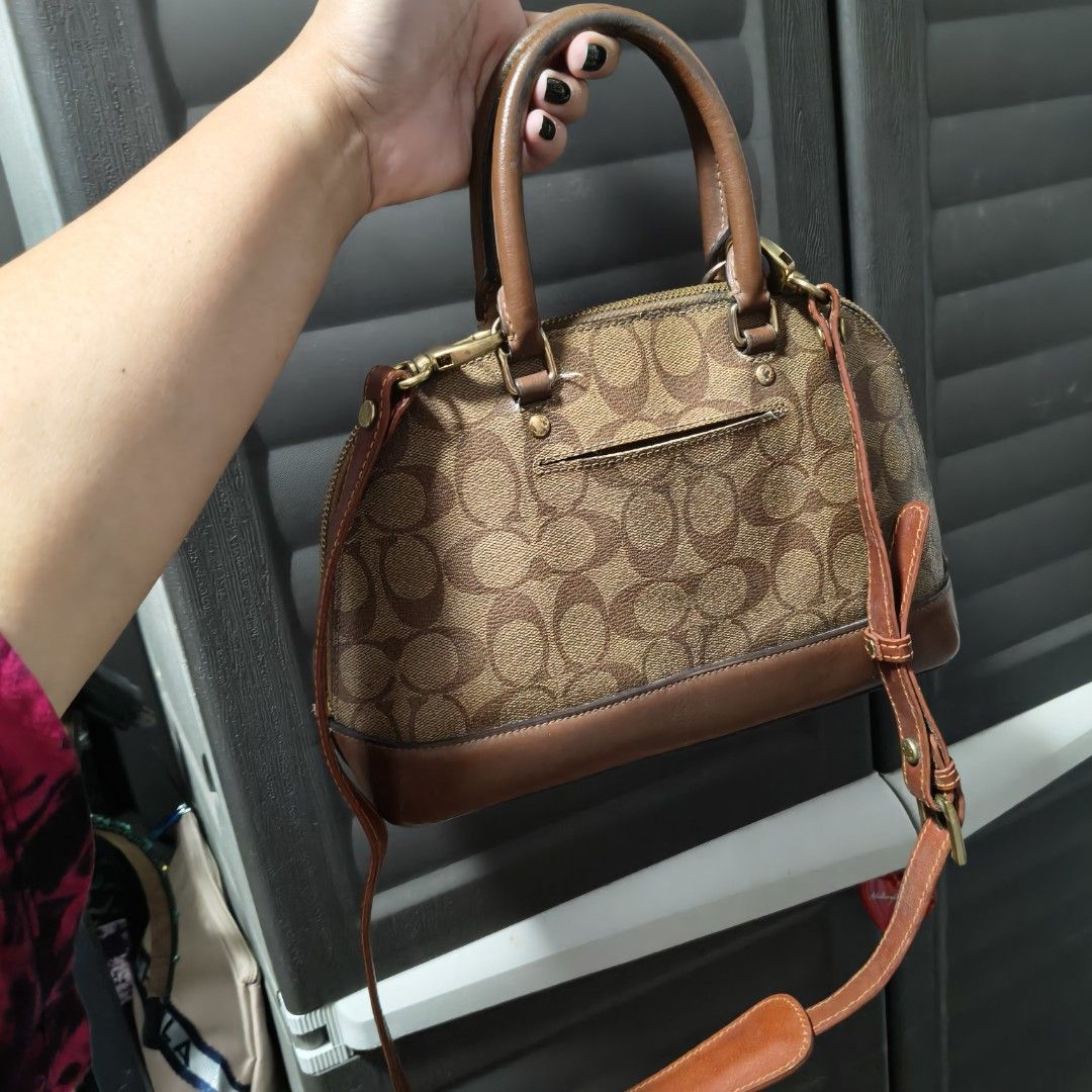 Coach Dome Satchel Handbag (Category: Cross-body Bags) located in Manila. Submitted by stuff_finder (Listing ID 1431189863, Image 3). Description: Coach dome satchel handbag with brown leather trim and signature logo print. Features a top handle and a detachable shoulder strap provided. The interior has a pocket. Includes a Coach hangtag. The bag has a zip closure. guaranteed authentic.