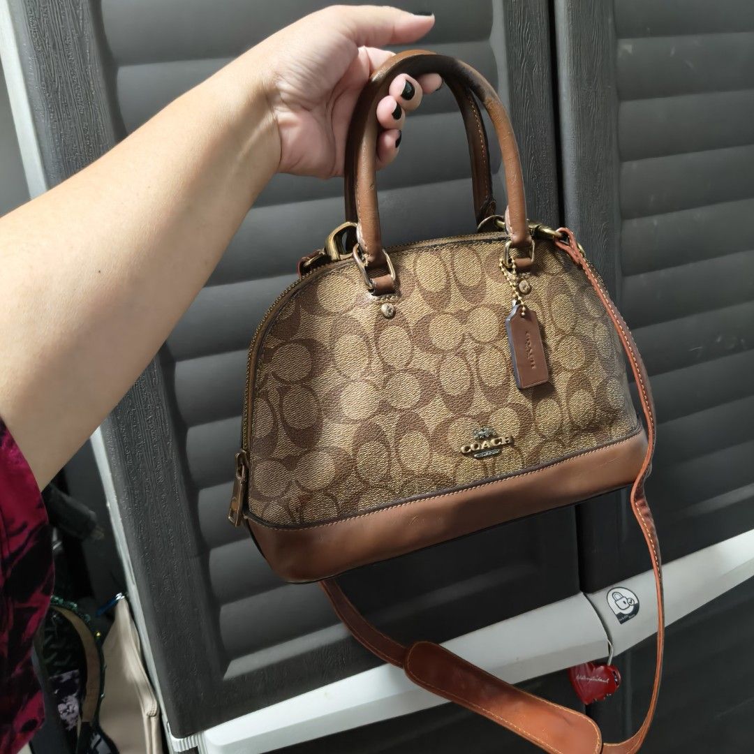 Coach Dome Satchel Handbag (Category: Cross-body Bags) located in Manila. Submitted by stuff_finder (Listing ID 1431189863, Image 1). Description: Coach dome satchel handbag with brown leather trim and signature logo print. Features a top handle and a detachable shoulder strap provided. The interior has a pocket. Includes a Coach hangtag. The bag has a zip closure. guaranteed authentic.
