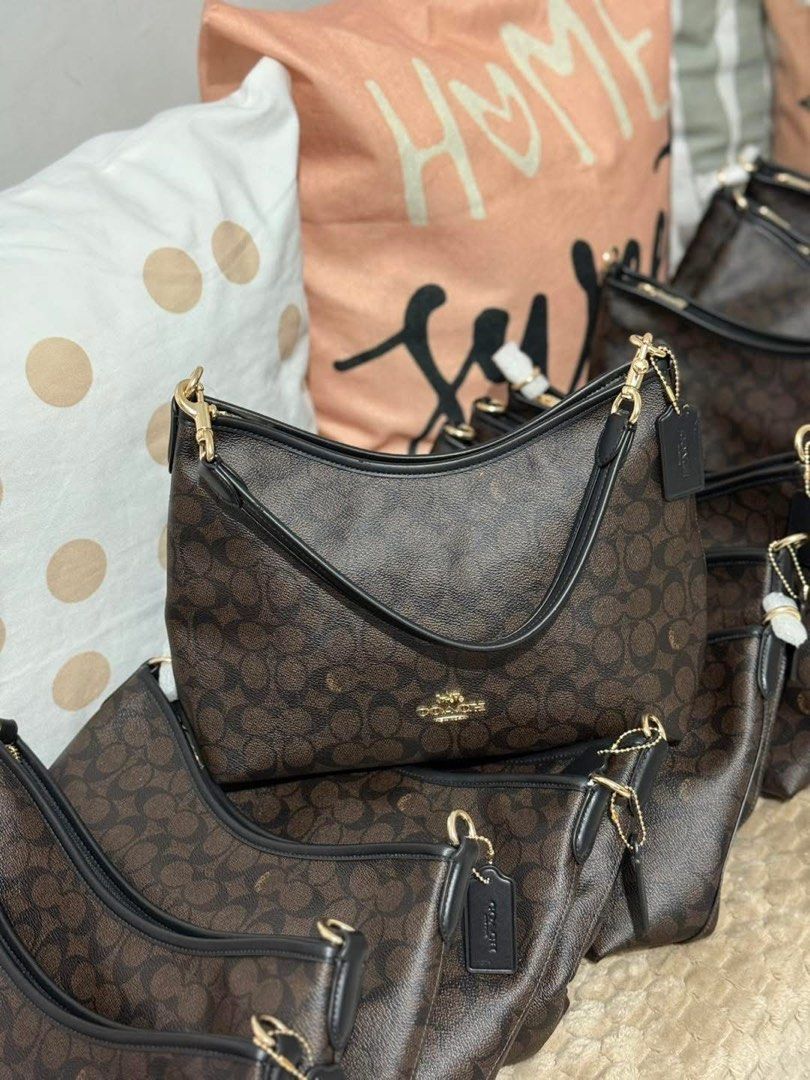 Coach Signature Shoulder Bag (Category: Shoulder Bags) located in Manila. Submitted by clairetot (Listing ID 1431337361, Image 2). Description: Coach shoulder bag in signature brown print. Features black leather strap, gold hardware, and detachable strap. Classic design with zippered closure..