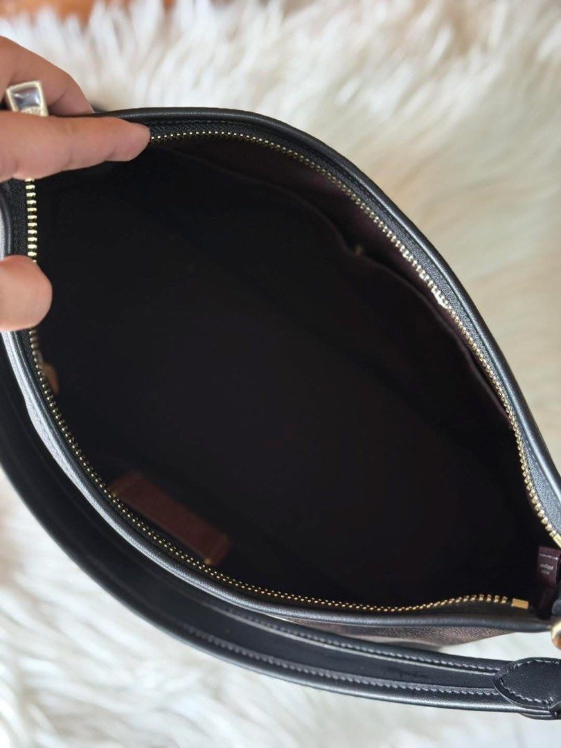 Coach Signature Shoulder Bag (Category: Shoulder Bags) located in Manila. Submitted by clairetot (Listing ID 1431337361, Image 3). Description: Coach shoulder bag in signature brown print. Features black leather strap, gold hardware, and detachable strap. Classic design with zippered closure..