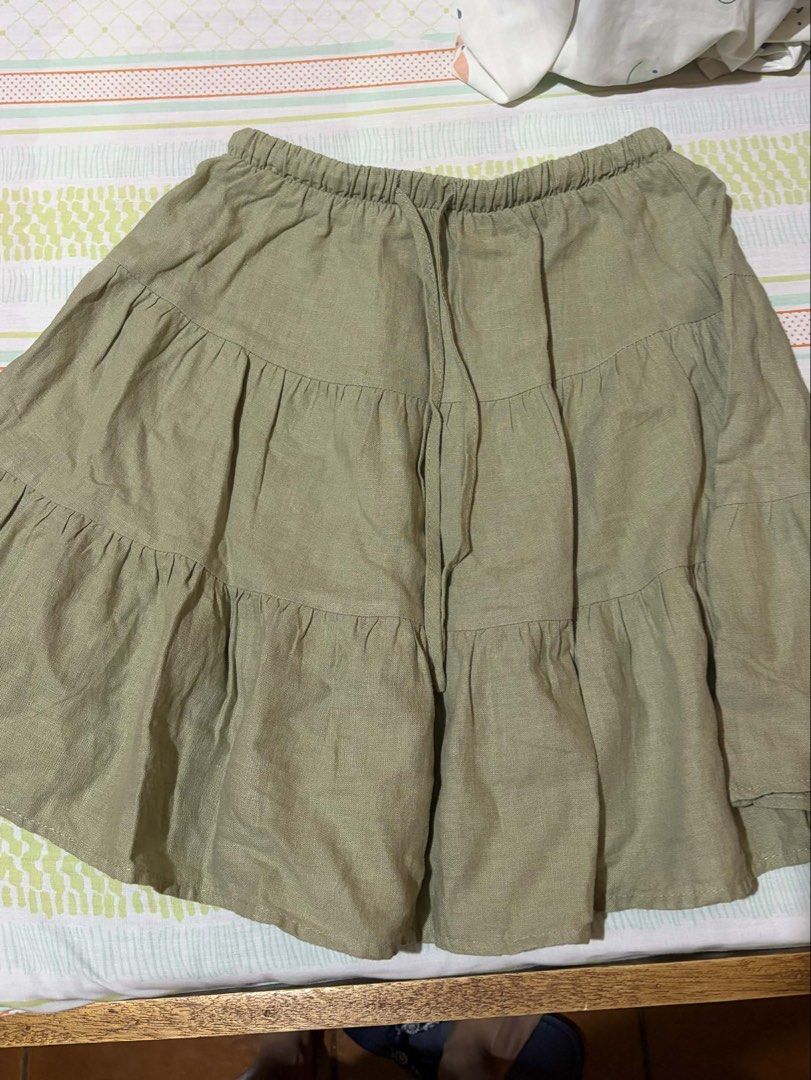 Cotton On Tiered Skirt (Category: Skirts) located in Cabuyao City. Submitted by declutter_w_mee (Listing ID 1431271794, Image 1). Description: Cotton On olive green tiered skirt. Size 4 AU/US. Features elastic waistband and drawstring..