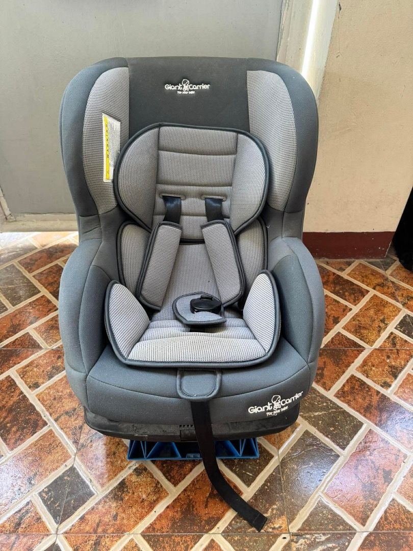 Giant Carrier Car Seat (Category: Car Seats) located in Malolos. Submitted by michellejinky (Listing ID 1431276582, Image 2). Description: Giant Carrier car seat is designed for child safety. It features a gray and black color scheme with a padded seat and headrest for comfort. The seat has a five-point harness system and a sturdy base. The car seat is suitable for various car models and is easy to install..
