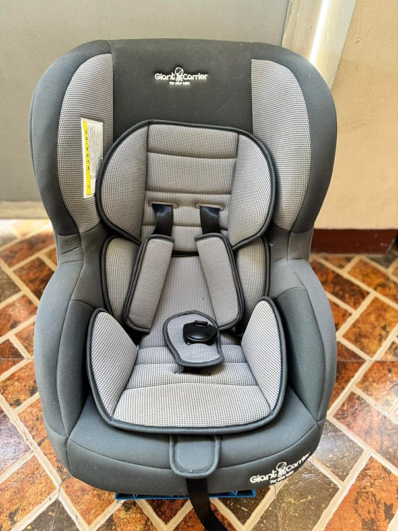 Giant Carrier Car Seat (Category: Car Seats) located in Malolos. Submitted by michellejinky (Listing ID 1431276582, Image 1). Description: Giant Carrier car seat is designed for child safety. It features a gray and black color scheme with a padded seat and headrest for comfort. The seat has a five-point harness system and a sturdy base. The car seat is suitable for various car models and is easy to install..