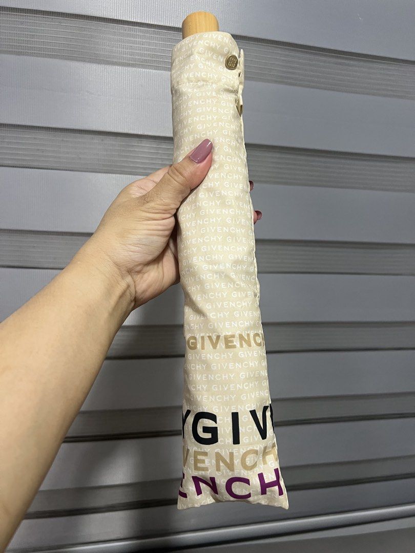 Givenchy Umbrella (Category: Umbrellas) located in Las Pinas. Submitted by maple0305 (Listing ID 1431320200, Image 1). Description: - Givenchy umbrella - Beige fabric with all-over brand print - Wooden handle - Button closure - Foldable and compact design - Easy to carry - White interior with Givenchy logo.