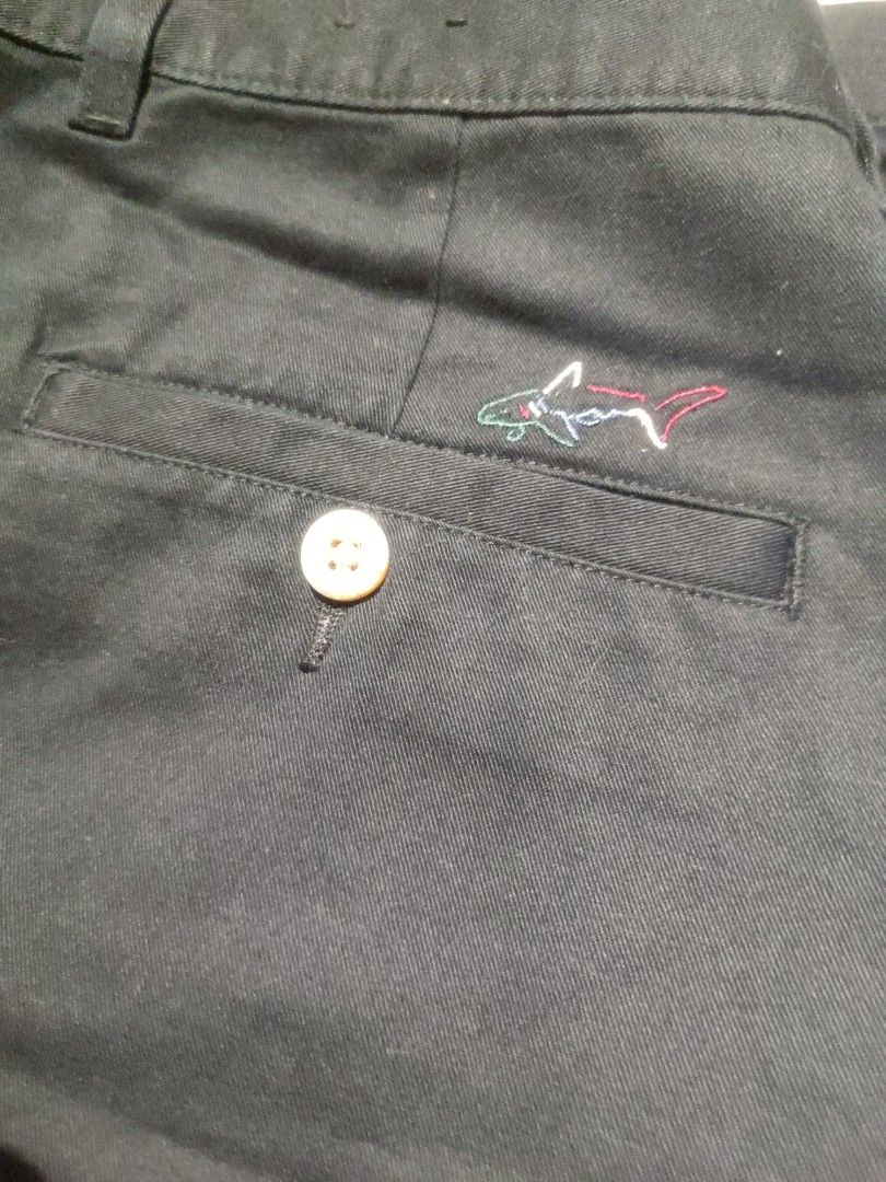 Greg Norman Golf Pants - Waist 36 (Category: Trousers) located in Baler. Submitted by onlyhuman_67 (Listing ID 1431349555, Image 3). Description: This is a pre-owned item but in very good condition. Picture may differ from actual color due to lighting. - Greg Norman golf pants - Size: 36 - Material: 100% cotton - Closure: Button - Design: Embroidered shark logo on pocket - Origin: Made in Indonesia - Color: Dark Navy.