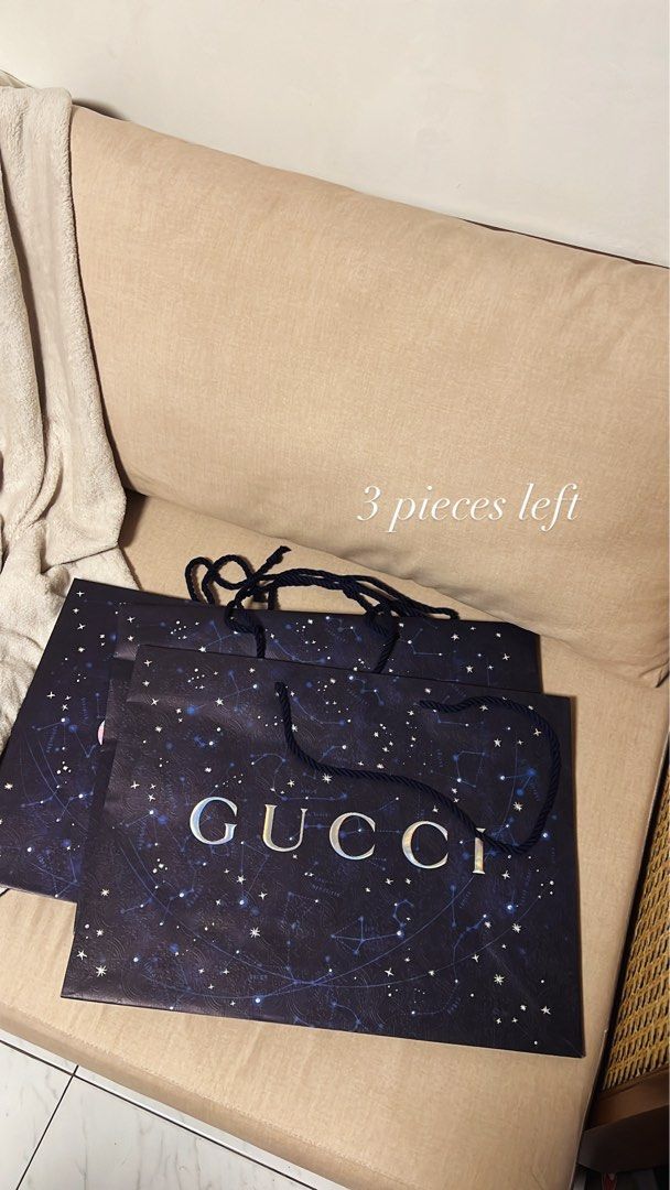 Gucci Paper Bag (Category: Luxury Bags & Wallets) located in Manila. Submitted by monicagellerbing__ (Listing ID 1431311431, Image 1). Description: - Authentic Gucci paper bag - Dark blue background with constellation design - Silver Gucci logo - Black rope handle - 3 pieces available.