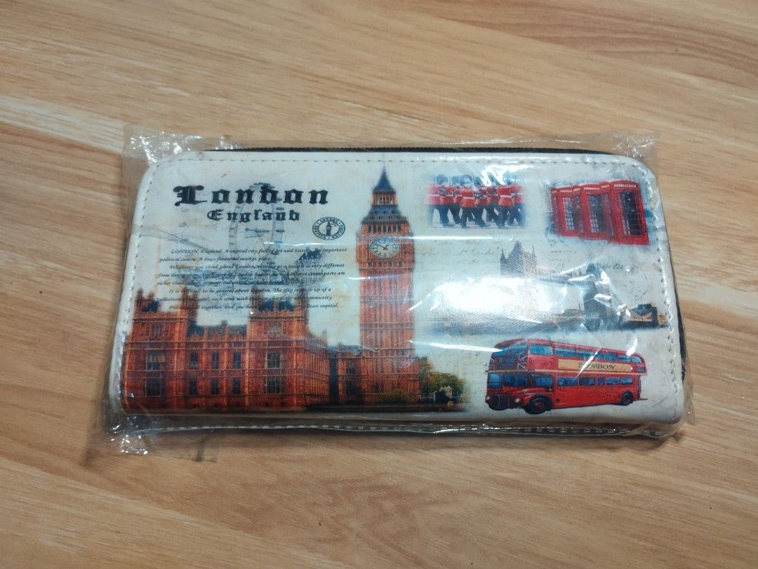 London England Print Wallet (Category: Wallets & Card holders) located in Carmona. Submitted by ichorvault (Listing ID 1431327220, Image 2). Description: - London England print on the front - Zipper closure - Multiple compartments for cards and cash - Light tan interior - New and unused.