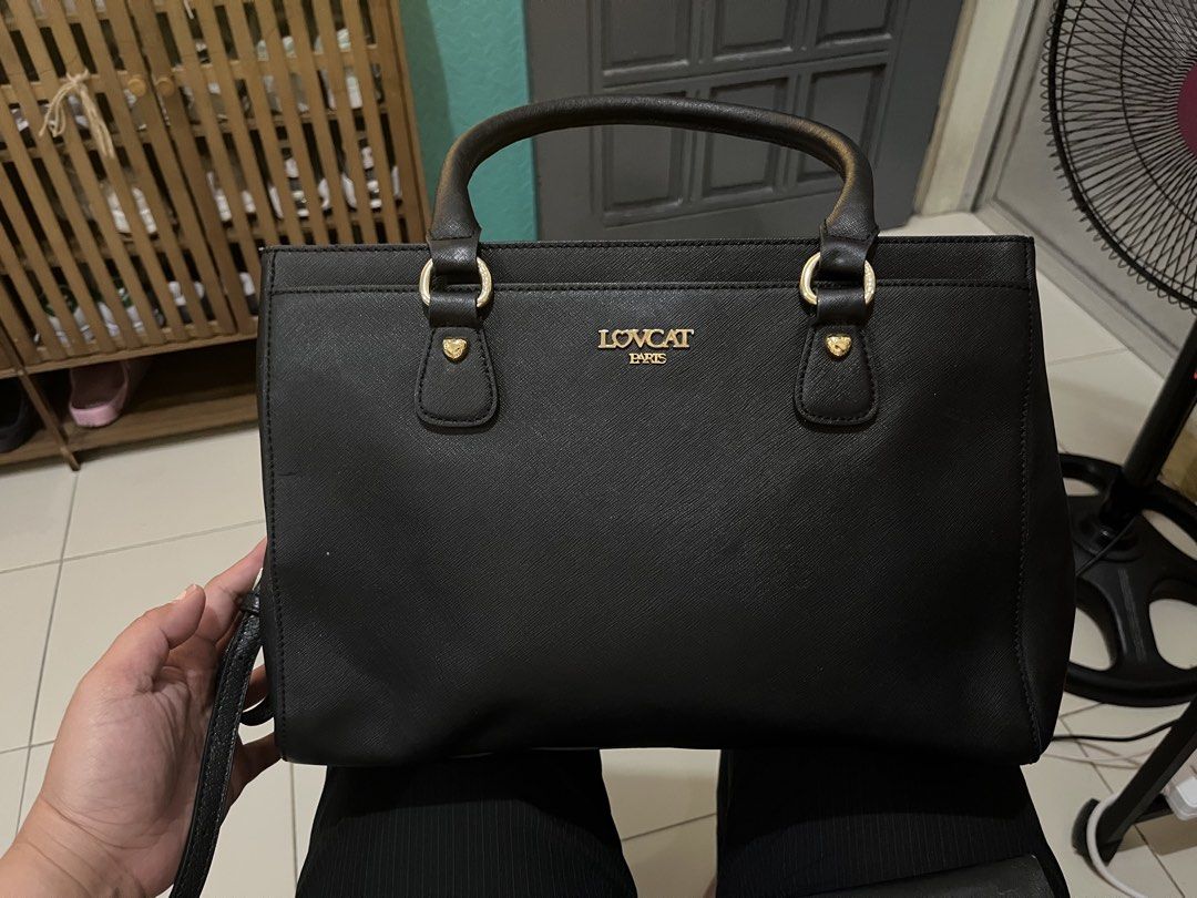LOVCAT Black 2-way Bag (Category: Luxury Bags & Wallets) located in Las Pinas. Submitted by preloved_koto (Listing ID 1431297375, Image 3). Description: - Black 2-way bag with a top handle and a detachable shoulder strap - Features gold-colored hardware on the handles - It has a rectangular shape with a zipper closure - comes with 3 compartments - Medium size.