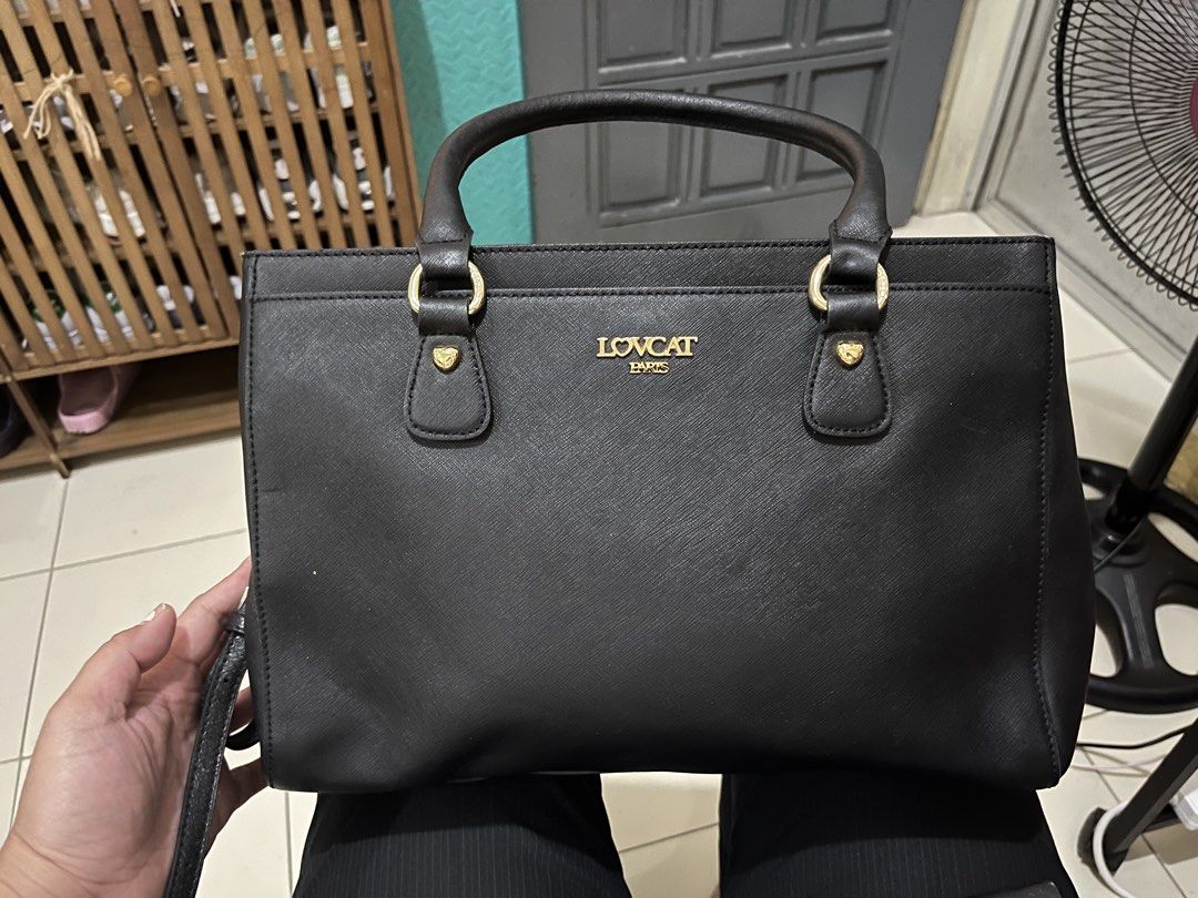 LOVCAT Black 2-way Bag (Category: Luxury Bags & Wallets) located in Las Pinas. Submitted by preloved_koto (Listing ID 1431297375, Image 2). Description: - Black 2-way bag with a top handle and a detachable shoulder strap - Features gold-colored hardware on the handles - It has a rectangular shape with a zipper closure - comes with 3 compartments - Medium size.