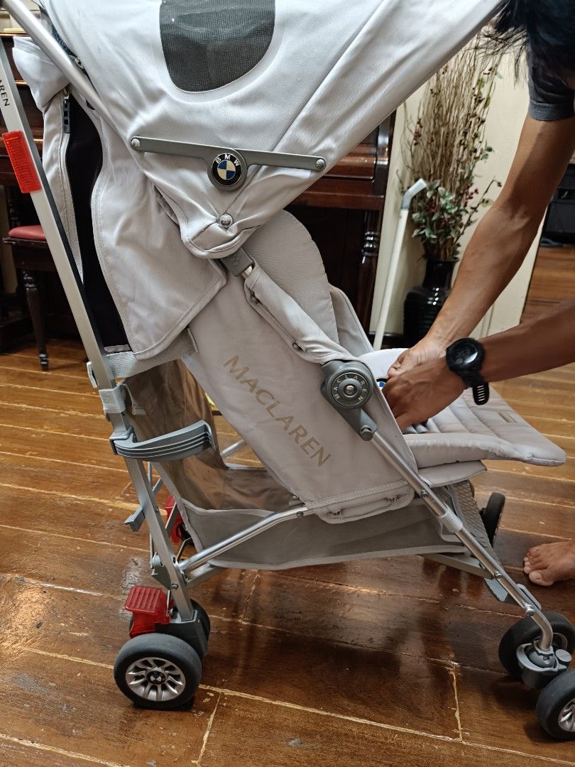 Maclaren BMW silver Stroller with raincover (Category: Strollers) located in Borongan. Submitted by khakiskye (Listing ID 1431185745, Image 1). Description: Maclaren BMW Buggy stroller in silver. Features a sunshade, a rain cover, and a storage basket. The stroller has a 5-point harness for safety. The wheels are designed for smooth maneuverability. The stroller has the BMW logo on the back. The stroller is foldable for easy storage and transport