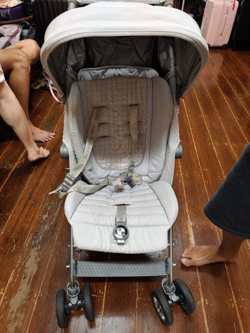 Maclaren BMW silver Stroller with raincover (Category: Strollers) located in Borongan. Submitted by khakiskye (Listing ID 1431185745, Image 2). Description: Maclaren BMW Buggy stroller in silver. Features a sunshade, a rain cover, and a storage basket. The stroller has a 5-point harness for safety. The wheels are designed for smooth maneuverability. The stroller has the BMW logo on the back. The stroller is foldable for easy storage and transport