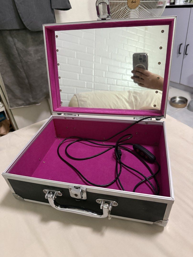 Makeup mirror vanity suitcase with lights (Category: Accessory Holder, Box & Organizers) located in Quezon City. Submitted by eiagarxia (Listing ID 1431242336, Image 1). Description: - Makeup mirror vanity suitcase with lights - Features built-in lights for perfect makeup application - Portable and easy to carry - Sleek black exterior - Stylish pink interior - Perfect for makeup artists and enthusiasts - white light with higher or lower bright mo