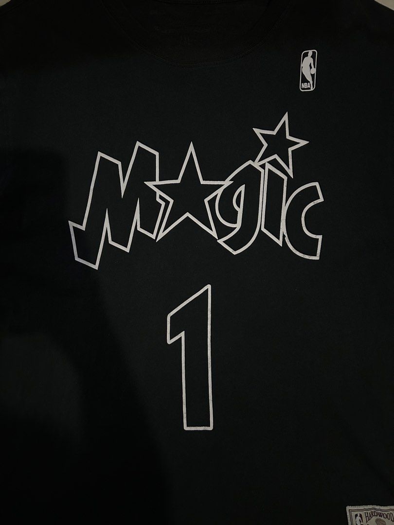 Mitchell & Ness Orlando Magic McGrady Jersey (Category: Tshirts & Polo Shirts ) located in San Fernando. Submitted by thrift_lang_ni_kim (Listing ID 1431278951, Image 2). Description: Width 22 Length 30 Black Mitchell & Ness Orlando Magic McGrady jersey. Features the Magic logo and number 1 on the front. The back displays the name McGrady and the number 1. Includes the NBA Hardwood Classics and Mitchell & Ness tags..