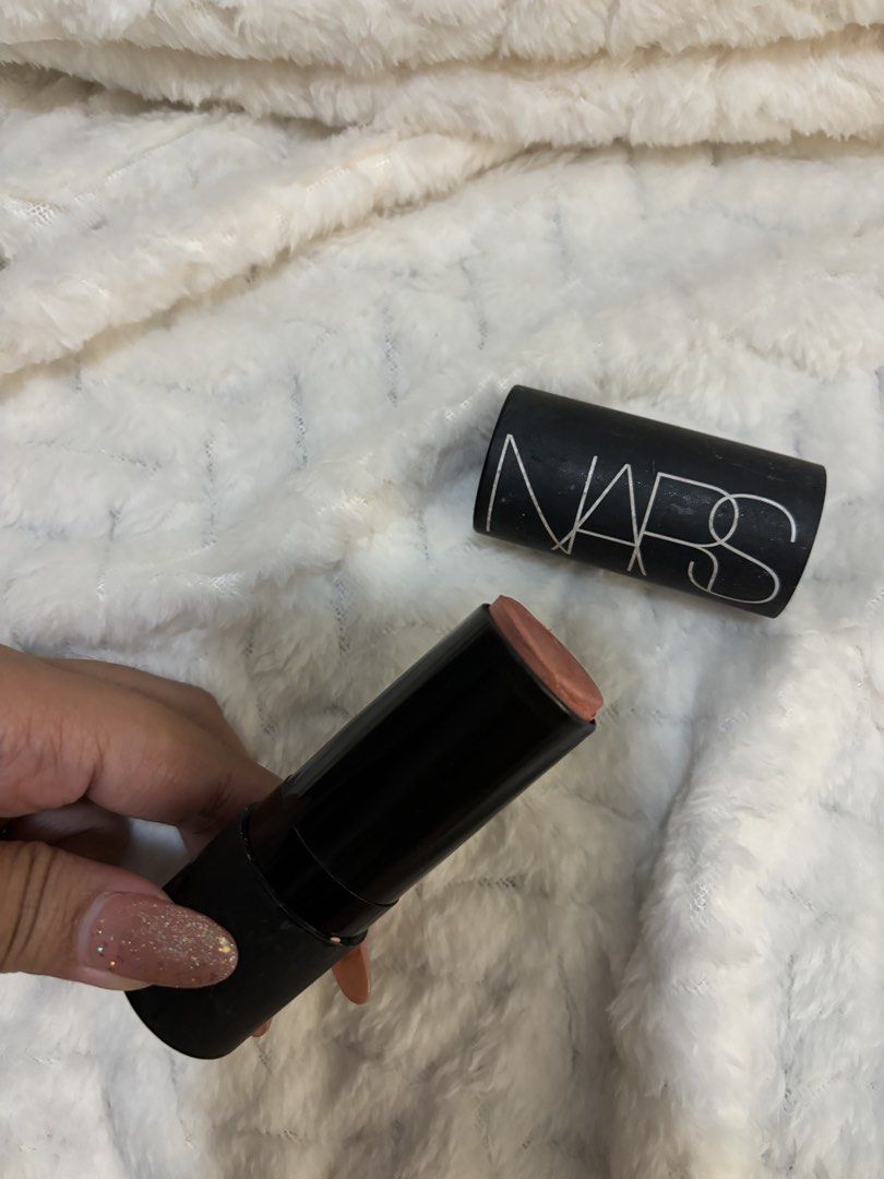 Nars Orgasm Blush Stick (Category: Makeup) located in Taguig. Submitted by hisandhers16 (Listing ID 1431340071, Image 2). Description: Authentic. Barely used. Retails for 2.5k. Nars Orgasm Multiple Stick. Full size. Can be used as blush on, lipstick and eyeshadow. Flaw: Medyo dusty yung black coating nung packaging since hindi nagagamit. Stored only hence the usual chipping of the packaging. But doesnt affect the actual product. Very pigmented, a