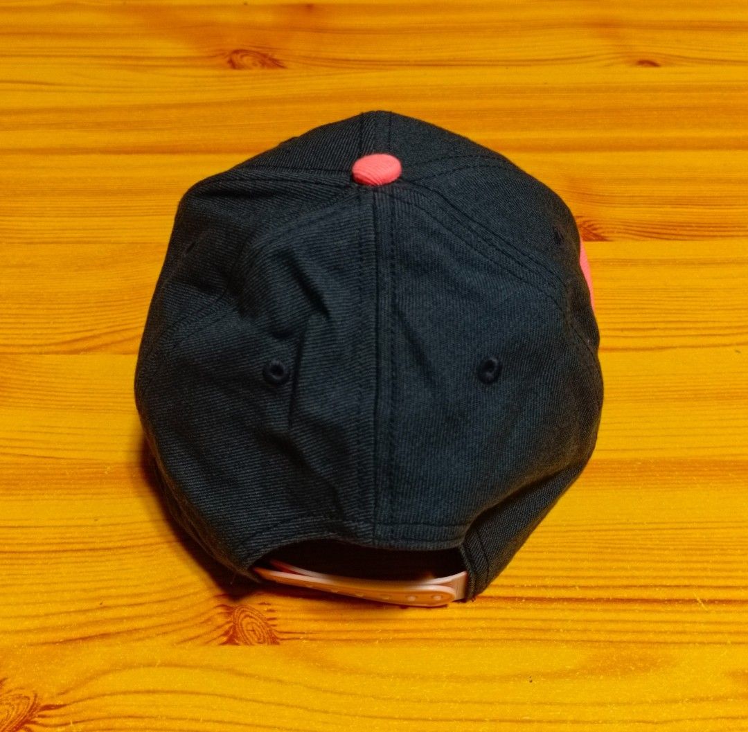 Nike True Cap (Category: Caps & Hats) located in Manila. Submitted by caps08 (Listing ID 1431232581, Image 3). Description: Nike True cap features a black crown with a pink brim. The Nike logo is prominently displayed on the front. The cap has a snapback closure. The tag indicates it is made in China. The interior features the Nike True logo and "Engineered to the Exact Specifications of Championship Athletes" printed on the lining..