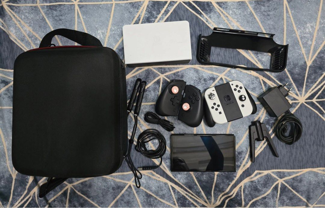Nintendo Switch Oled Bundle (Category: Nintendo) located in Taguig. Submitted by peachy_izzy (Listing ID 1431234265, Image 1). Description: Nintendo Switch OLED edition -12k Comes with all original parts: Left and Right Joy-cons 2 Joy-con straps Joy-con charging grip Nintendo switch adapter/charger HDMI Cord Nintendo switch Dock Comes with other accessories: hard carrying case/bag IINE charging grip IINE Switch elite joypad Silicone case (Black).