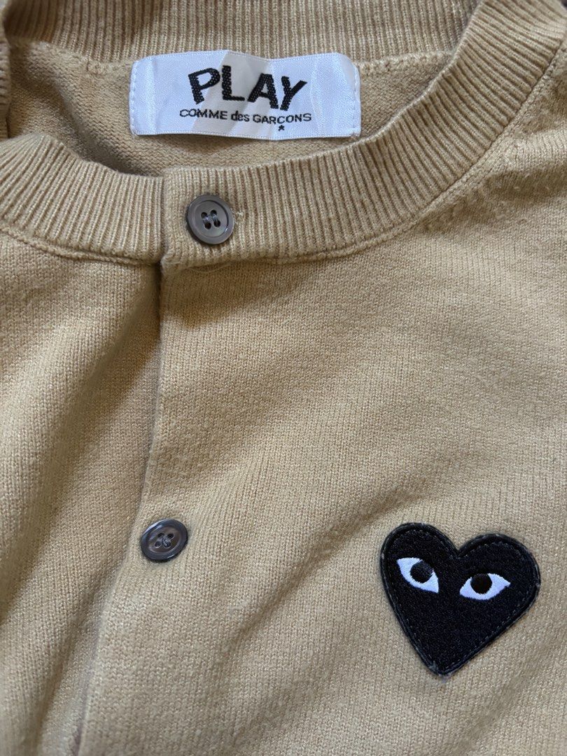 Play Comme des Garcons Khaki Knit Cardigan (Category: Longsleeves) located in Cebu City. Submitted by stylingtrends.coll (Listing ID 1431204558, Image 1). Description: •khaki •knitted •front button fastening •logo patch at the chest •long sleeves •ribbed cuffs and hem.