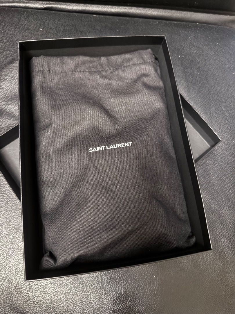 Saint Laurent Clutch (Category: Luxury Bags & Wallets) located in Pasig City. Submitted by ladyjesuit (Listing ID 1431335384, Image 2). Description: - Saint Laurent clutch - Neutral color - Includes original box, dust bag, and authenticity cards - Gold-tone logo and zipper - Soft fabric interior - Stylish and practical.