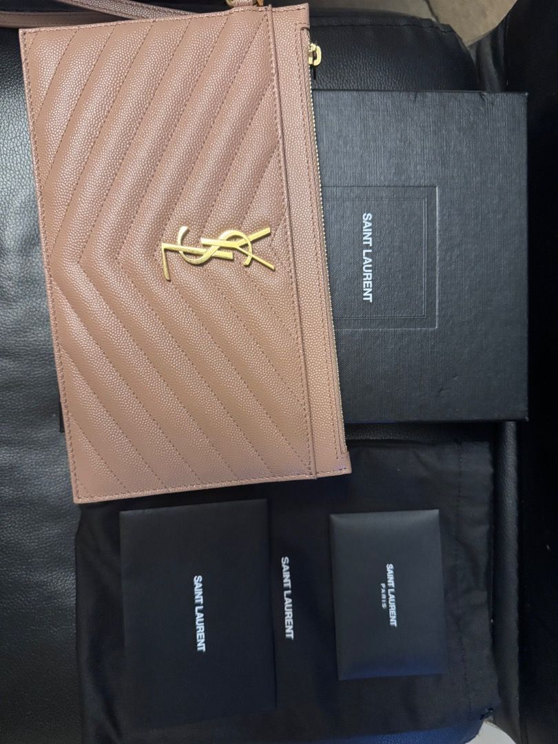 Saint Laurent Clutch (Category: Luxury Bags & Wallets) located in Pasig City. Submitted by ladyjesuit (Listing ID 1431335384, Image 3). Description: - Saint Laurent clutch - Neutral color - Includes original box, dust bag, and authenticity cards - Gold-tone logo and zipper - Soft fabric interior - Stylish and practical.