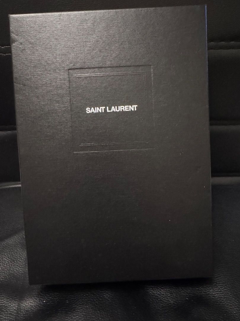 Saint Laurent Clutch (Category: Luxury Bags & Wallets) located in Pasig City. Submitted by ladyjesuit (Listing ID 1431335384, Image 1). Description: - Saint Laurent clutch - Neutral color - Includes original box, dust bag, and authenticity cards - Gold-tone logo and zipper - Soft fabric interior - Stylish and practical.