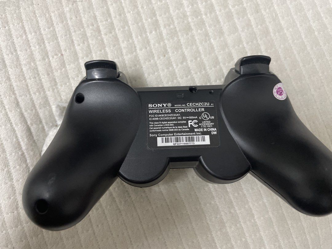Sony Wireless PS3 Controller (Category: Controllers) located in Kuala Lumpur. Submitted by ejenaliist88803 (Listing ID 1431289669, Image 2). Description: - Sony wireless controller for PlayStation. - Standard button layout with directional pad, action buttons, and analog sticks. - Model number: CECHZC2U. - Features Sony logo and markings. - Color: Black. - Can nego slightly..