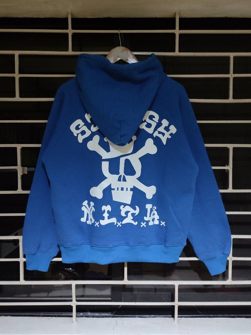 Stussy Gear Hoodie (Category: Hoodies) located in Antipolo. Submitted by thriftedjames (Listing ID 1431332353, Image 2). Description: - Stussy Gear hoodie - Color: Blue - Size: M - Design: Front logo and skull graphic on the back - Features: Drawstring hood and kangaroo pocket - Material: Comfortable - Style: Casual and versatile.