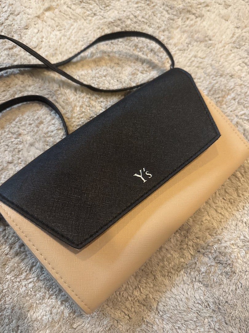 Yohji Yamamoto Y's Crossbody Wallet Bag - Black and Beige (Category: Cross-body Bags) located in Singapore. Submitted by greatworldand (Listing ID 1431223917, Image 1). Description: - Stylish Y's crossbody wallet bag - Classic black and beige color - Multiple compartments for cards and cash - Zippered pocket for security - Includes a long strap - Perfect for everyday use.