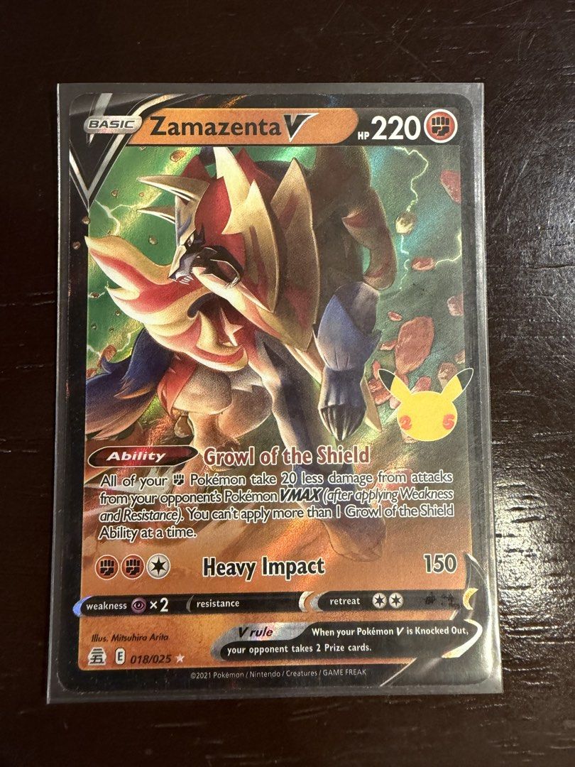 Zamazenta V 018/025 - Celebrations (Category: Raw Singles) located in Las Pinas. Submitted by johnsantos10 (Listing ID 1431329543, Image 1). Description: - Zamazenta V card from the Celebrations set. - HP: 220 - Ability: Growl of the Shield - Attack: Heavy Impact - Illustrator: Mitsuhiro Arita - Card Number: 018/025 - V rule card: Take 2 Prize cards if knocked out..