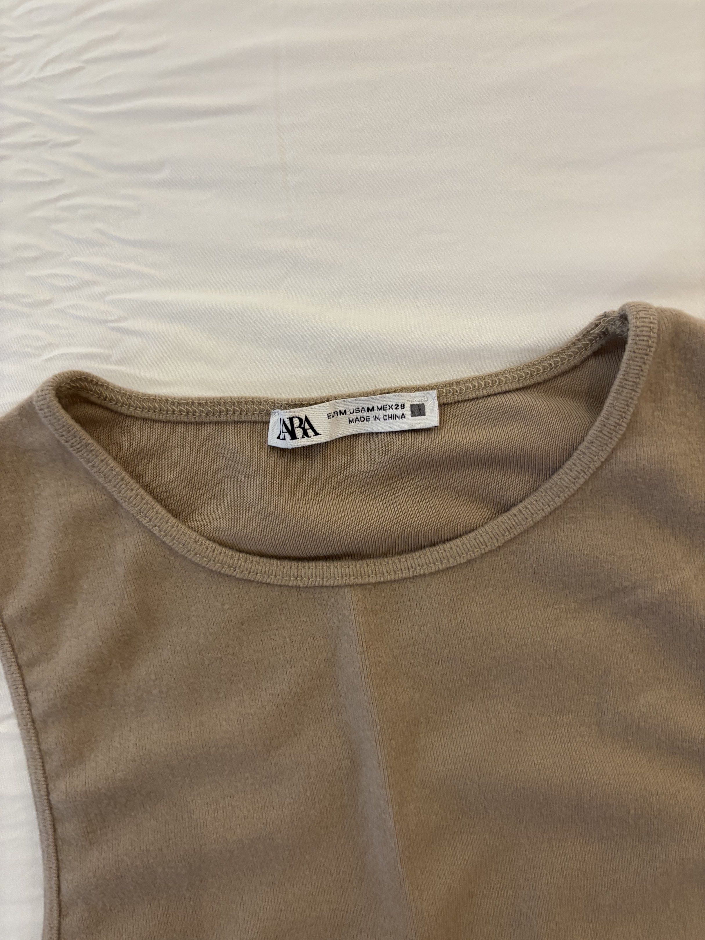 Zara Tank Top - Size M (Category: Sleeveless) located in Makati City. Submitted by user7633 (Listing ID 1431303671, Image 3). Description: - Zara knit tank top / crop top - Size: M - Sleeveless design - Neutral color - Versatile for various outfits - Made in China.