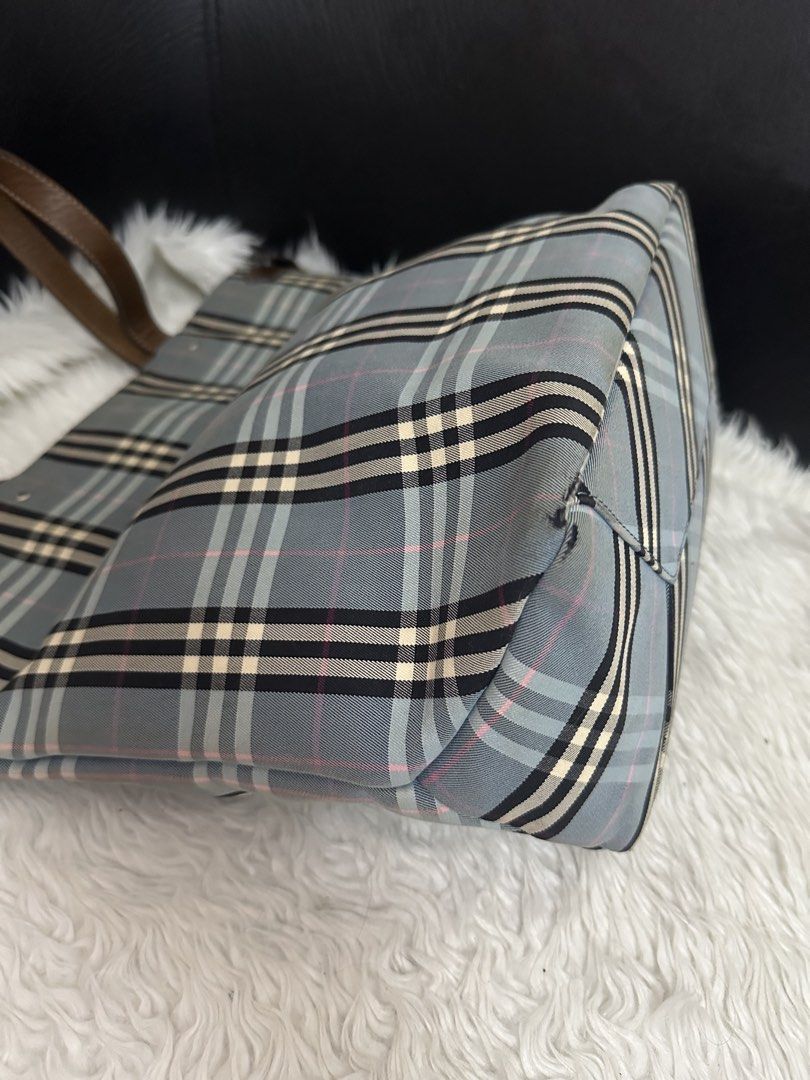 Burberry Blue Label Tote Bag (Category: Luxury Bags & Wallets) located in Marilao. Submitted by curleylux (Listing ID 1431413246, Image 3). Description: - Burberry Blue Label tote bag - Classic check pattern - Brown leather handles and trim - Interior zip pocket - Spacious interior - Exterior wear on corners - Magnetic snap closure.