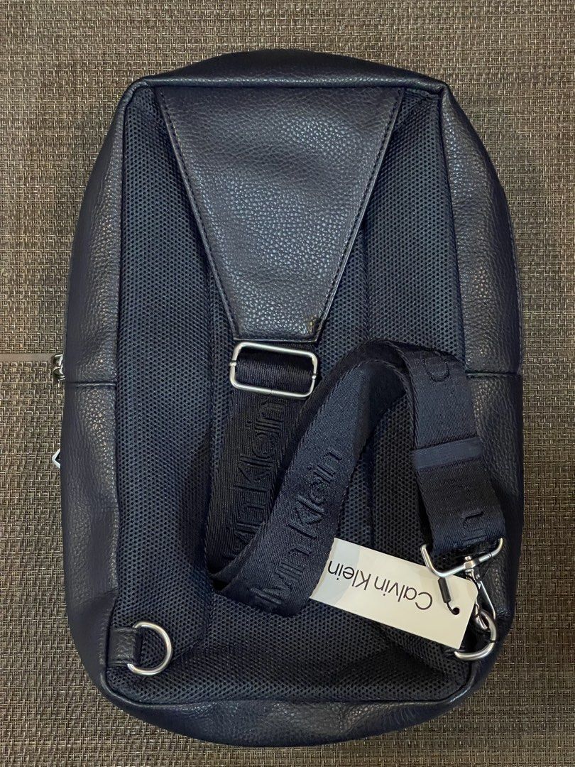 Calvin Klein Blue Leather Large Body Bag (Category: Backpacks) located in Quezon City. Submitted by mimi_declutters (Listing ID 1431404314, Image 3). Description: - Brand new Calvin Klein backpack - Color: Navy blue - Features: - Front pocket - Main compartment - CK logo zippers - Mesh back panel - Calvin Klein branded strap - Includes original tag with $129.50 price - AUTHENTICITY GUARANTEED SLIGHTLY NEGOTIABLE.