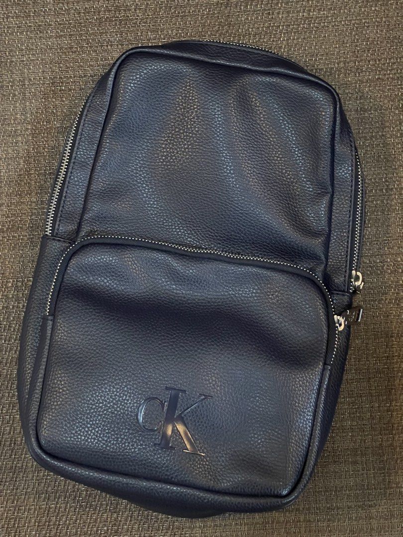 Calvin Klein Blue Leather Large Body Bag (Category: Backpacks) located in Quezon City. Submitted by mimi_declutters (Listing ID 1431404314, Image 1). Description: - Brand new Calvin Klein backpack - Color: Navy blue - Features: - Front pocket - Main compartment - CK logo zippers - Mesh back panel - Calvin Klein branded strap - Includes original tag with $129.50 price - AUTHENTICITY GUARANTEED SLIGHTLY NEGOTIABLE.